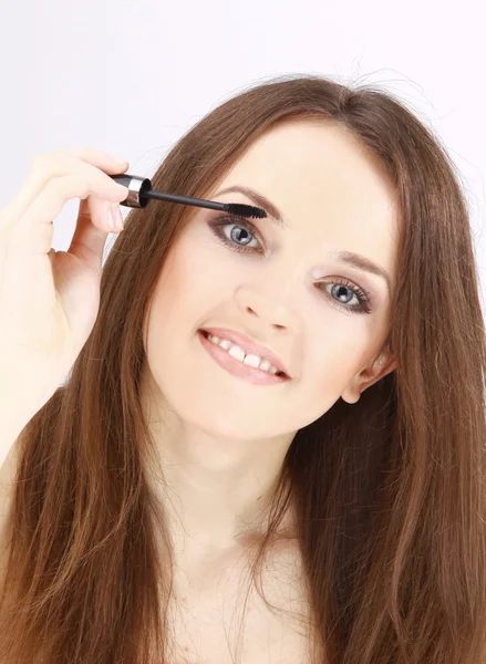 Portrait of attractive young adult woman applying blusher — Stock Photo, Image