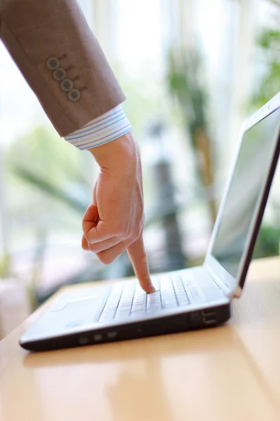 Палець вказує на клавіатуру комп'ютера ноутбука — стокове фото