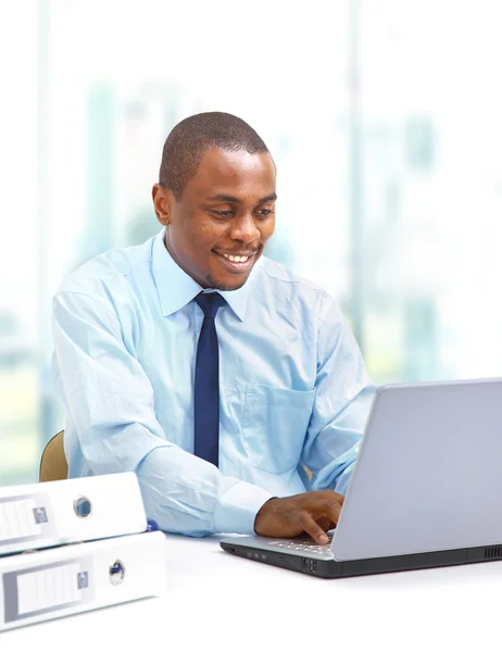 Portrait of a handsome young business man with a laptop — Stock Photo, Image