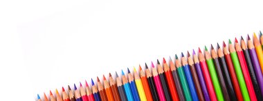 Assortment of coloured pencils with shadow on white background clipart