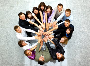 Top view of business with their hands together in a circle clipart