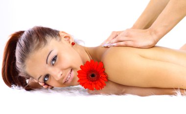 Portrait of a young woman being massaged clipart