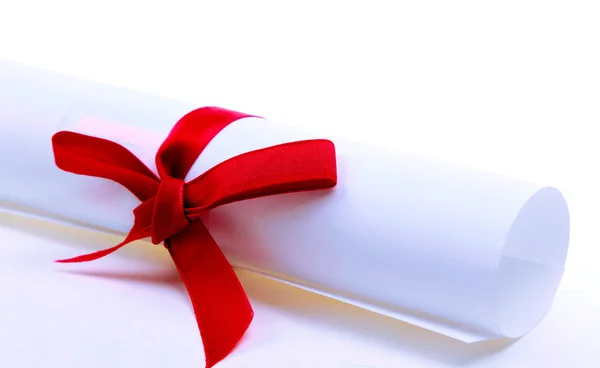 Paper scroll and red bow isolated on white backgrou — Stock Photo, Image