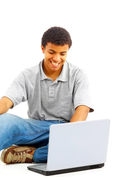Glücklicher junger Mann, der an einem Laptop arbeitet, isoliert vor weißem Hintergrund — Stockfoto