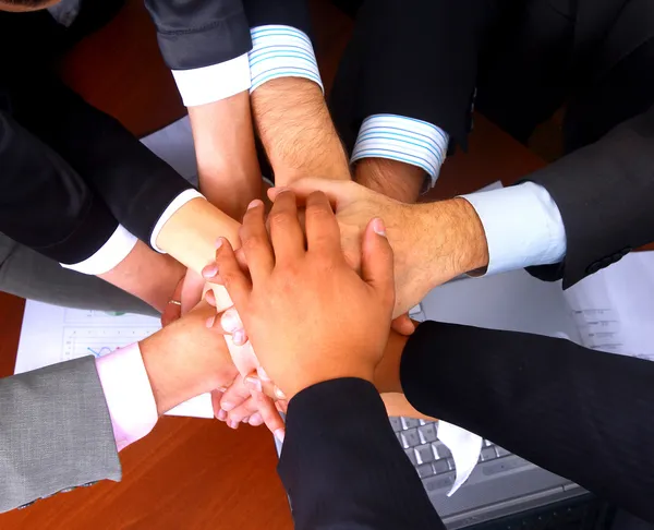 Group of business making a pile of hands in a light and modern offic — Stock Photo, Image