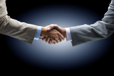 Handshake - Hand holding on black background clipart