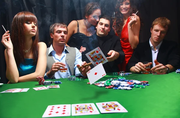 Stylish man in black suit folds two cards in casino poker at Las Vegas over — Stock Photo, Image