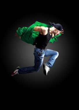 Modern dancer poses in front of the old dirty wall clipart