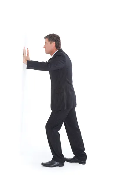 Isolated portrait of a senior business man pushing against the wall — Stock Photo, Image