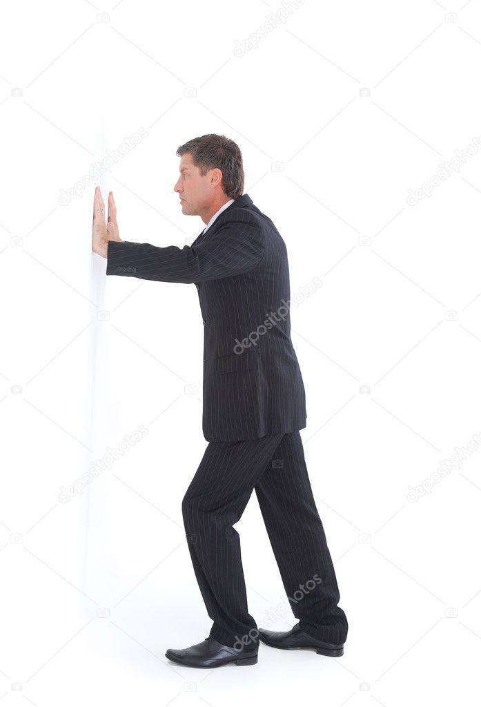 Isolated portrait of a senior business man pushing against the wall
