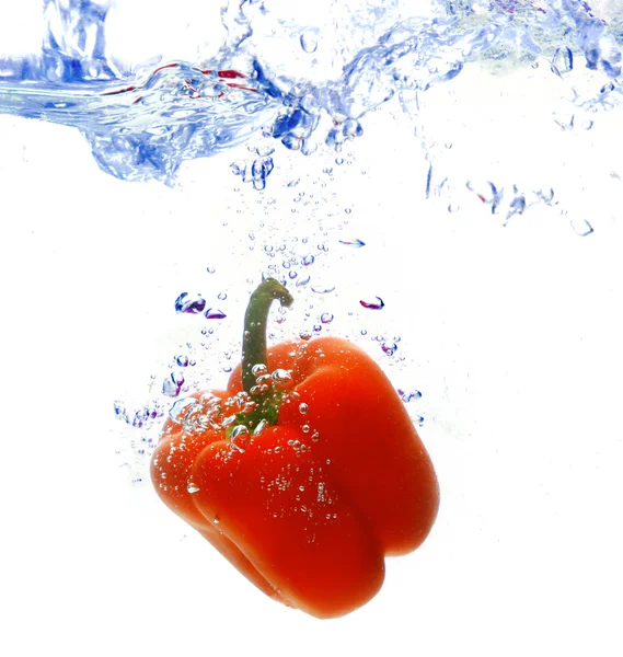 stock image Red pepper are dropped into water