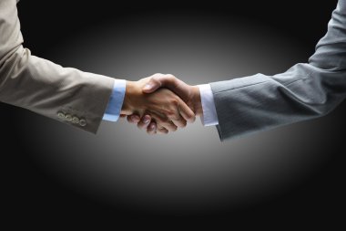 Handshake - Hand holding on black background clipart