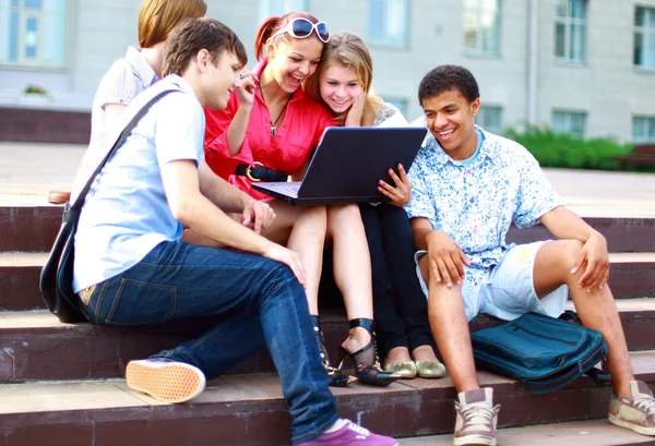 Group of five students outside sitting on steps — Stock Photo, Image