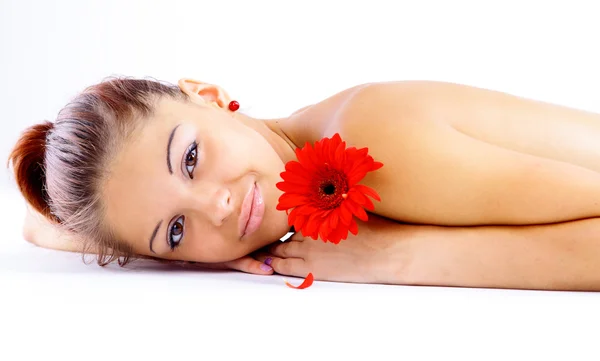 Beautiful young girl with flowers is relaxing — Stock Photo, Image