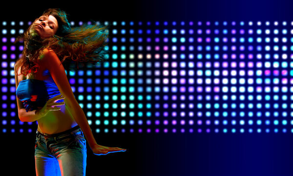 Beautiful young woman dancing in the nightclub