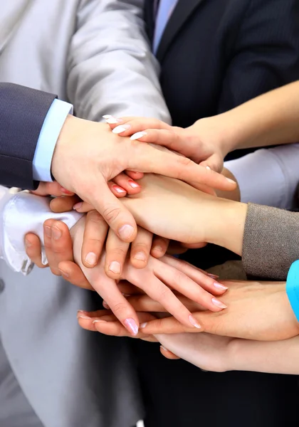 Hands piled on top of one another. Stock Photo