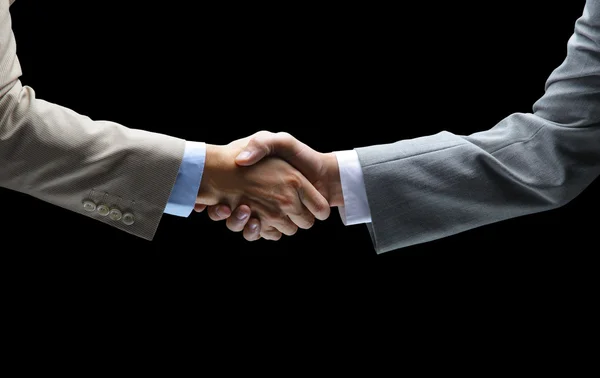 Handshake - Hand holding on black background — Stock Photo, Image