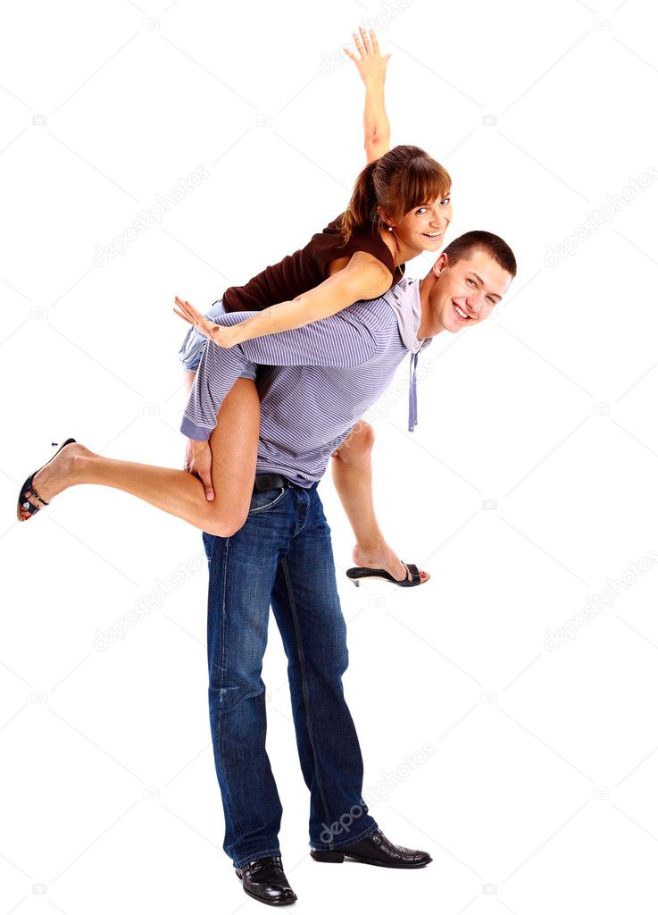 Happy young female enjoying a piggyback ride on boyfriends back against whi