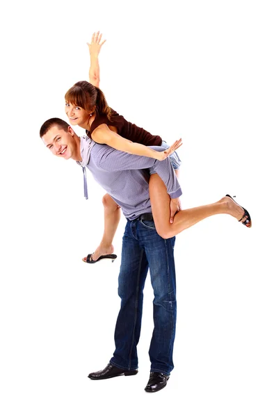 Happy young female enjoying a piggyback ride on boyfriends back against whi — Stock Photo, Image