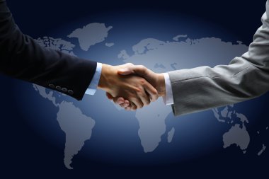 Handshake with map of the world in background clipart