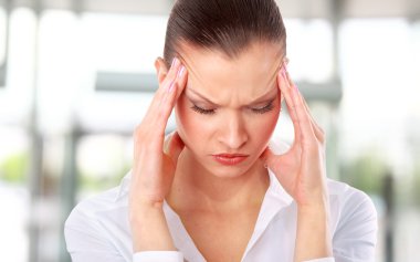 Young woman suffering a headache over white background clipart