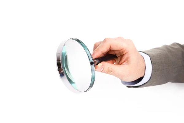Magnifying glass in hand isolated over white background — Stock Photo, Image