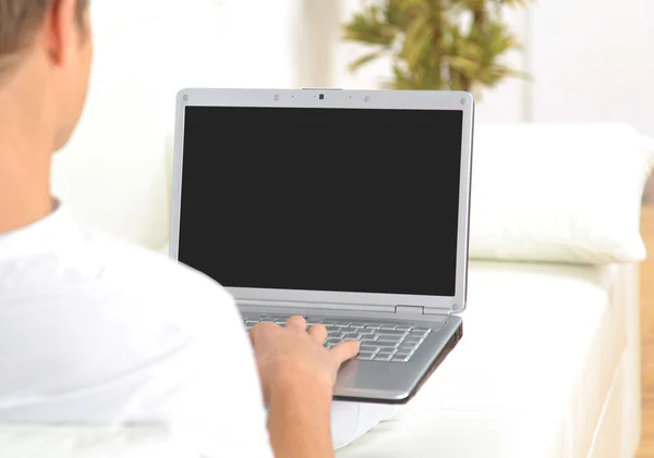 Vista trasera primer plano de un joven que trabaja en un ordenador portátil — Foto de Stock