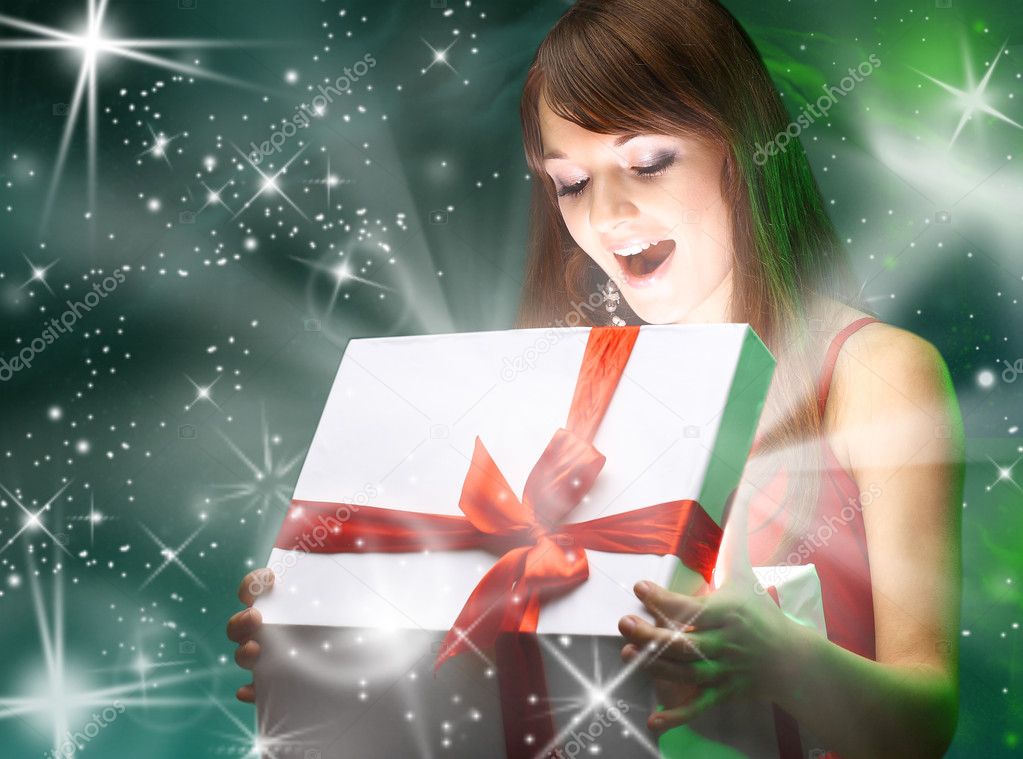 Beautifull girl opening x-mass magic present. Christmas
