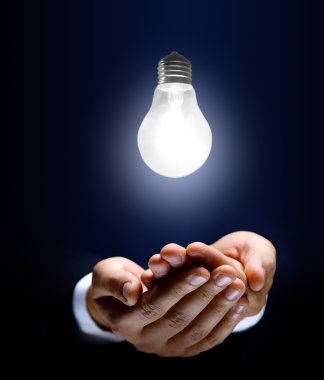 Glowing lightbulb and hand clipart