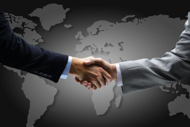 Handshake with map of the world in background clipart