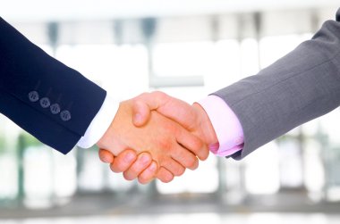 Business men hand shake in the office clipart