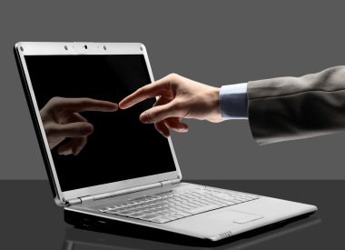 Close-up of male hand with forefinger pointing at laptop screen over black clipart