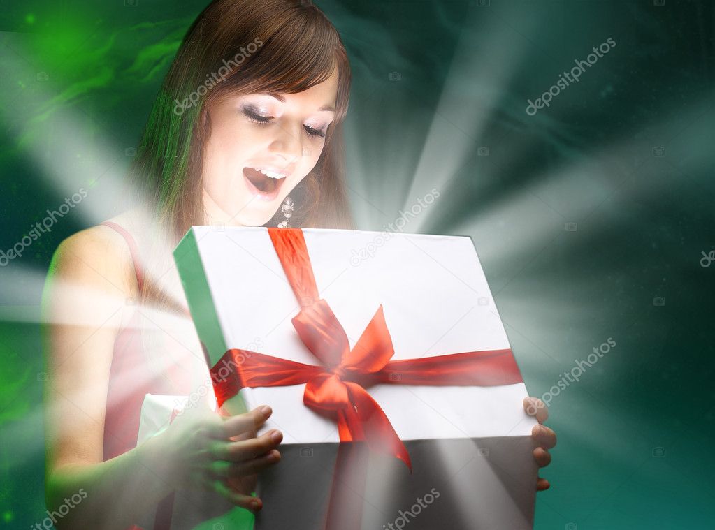 Beautifull girl opening x-mass magic present