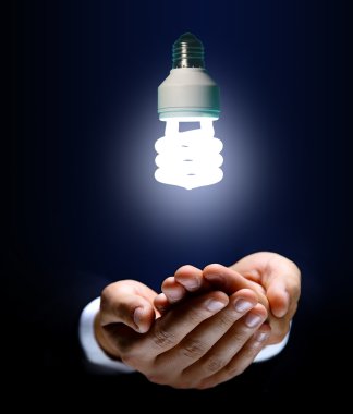 Glowing light bulb and hand clipart