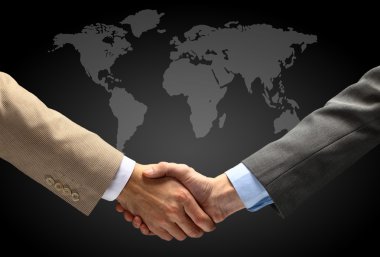 Handshake with map of the world in background clipart