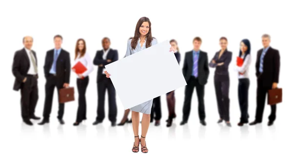 Businesswoman standing and holding a white empty billboard — Zdjęcie stockowe