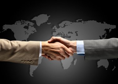 Handshake with map of the world in background clipart