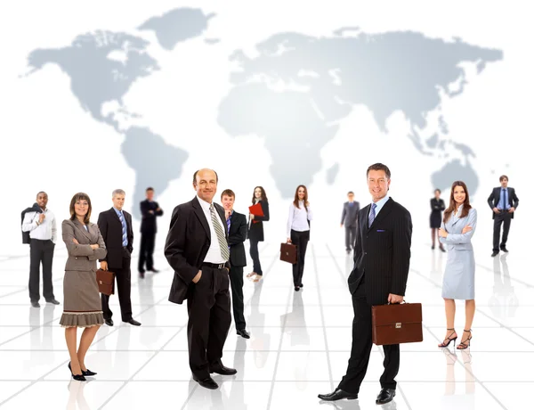 Businessmen standing in front of an earth map Stock Photo