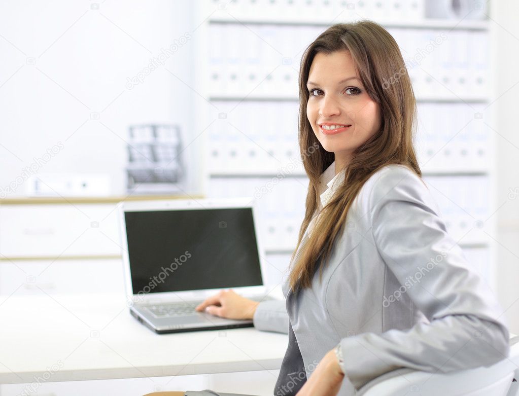 Business woman showing blank laptop