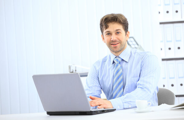 Closeup of employee in the office working on laptop computer