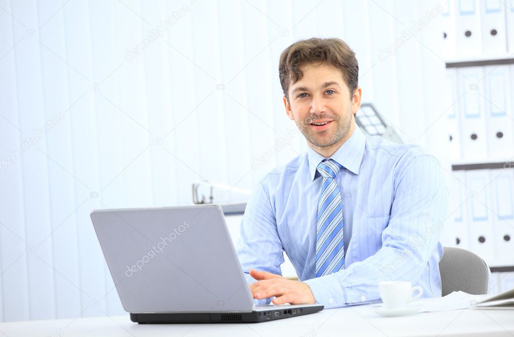 Closeup of employee in the office working on laptop computer