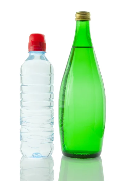 Bottles of mineral water reflected on white bac — Stock Photo, Image
