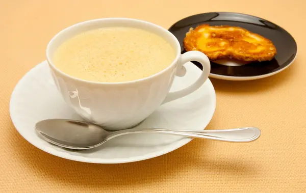 Closeup of coffee with milk in white cup and a p — Stock Photo, Image