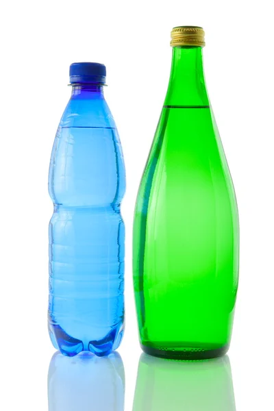 Bottles of mineral water reflected on white bac — Stock Photo, Image