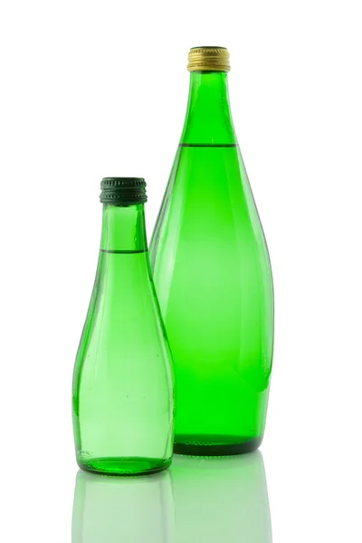 stock image Bottles of mineral water reflected on white bac