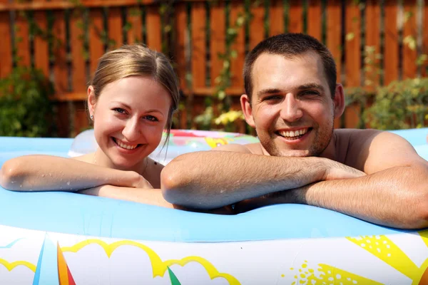 stock image Young pair bathes in inflatable pool