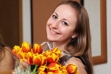 Blonde holding bunch of flowers