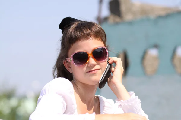 Küçük kız telefon ederken — Stok fotoğraf