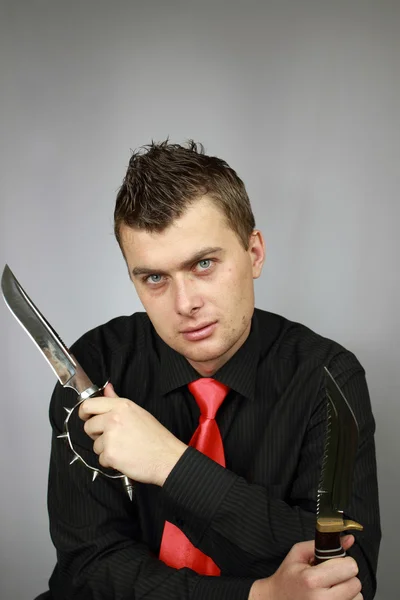 Бизнесмен с ножом — стоковое фото