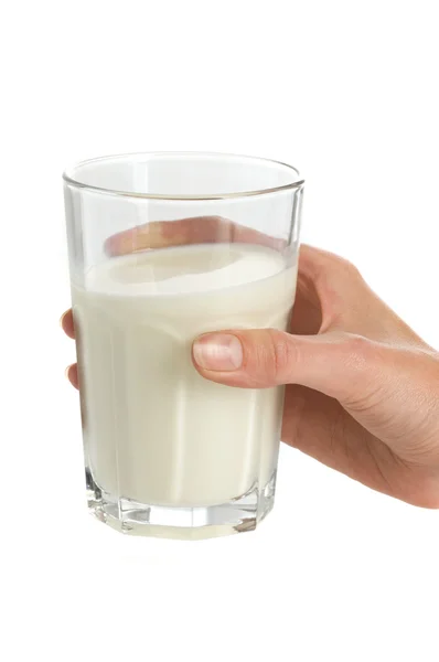 Glass of milk in hand — Stock Photo, Image